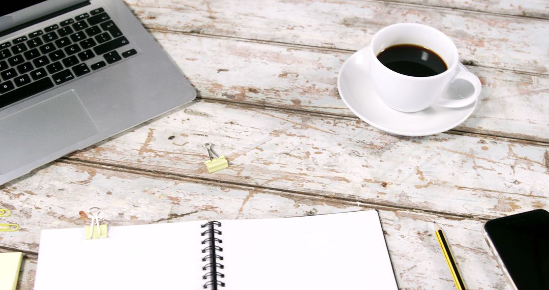 Personal rhythm planning desk with notebook and tea